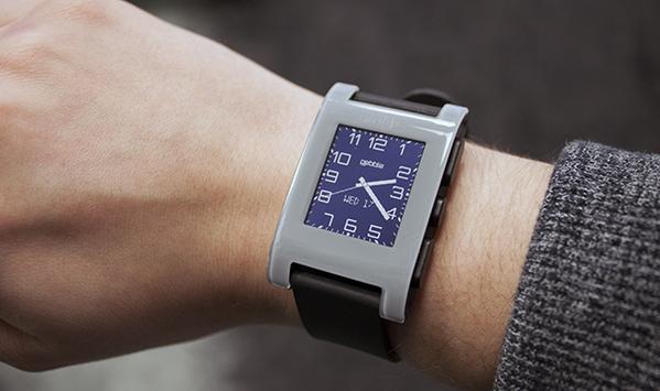 Photograph of a Pebble smart watch on someone's left hand.