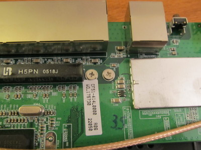 Close-up photograph of the two screws holding the circuit board to its case mount.